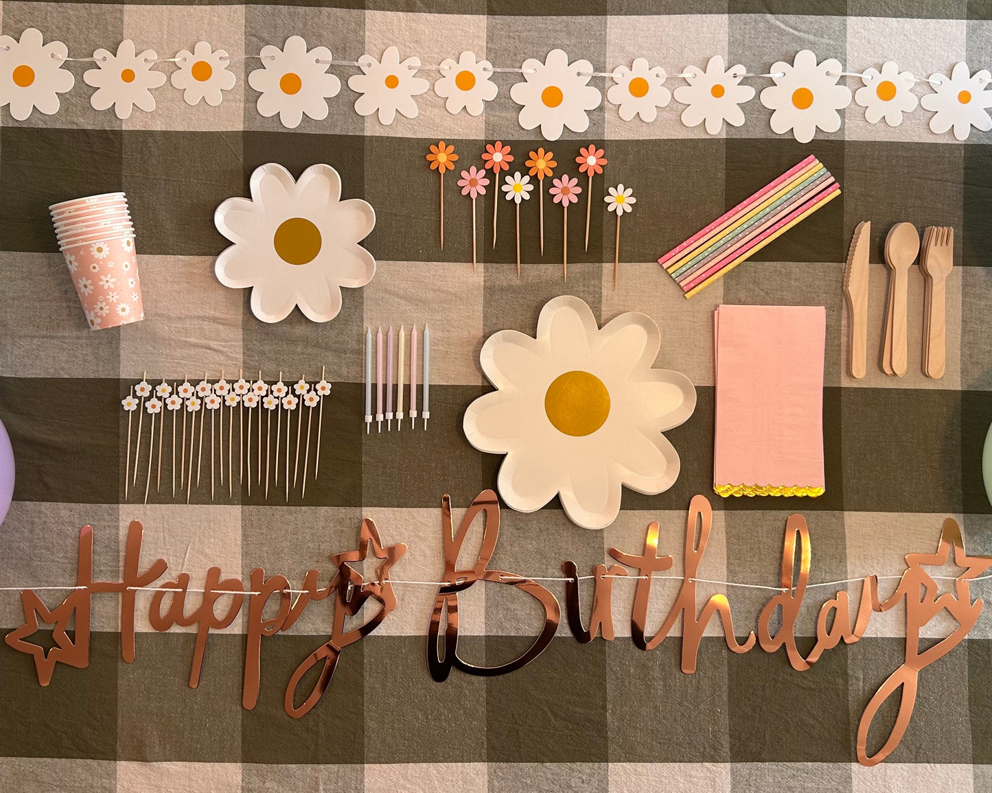 Birthday decorations including flowers, balloons, and 'Happy Birthday' banner on a checkered background