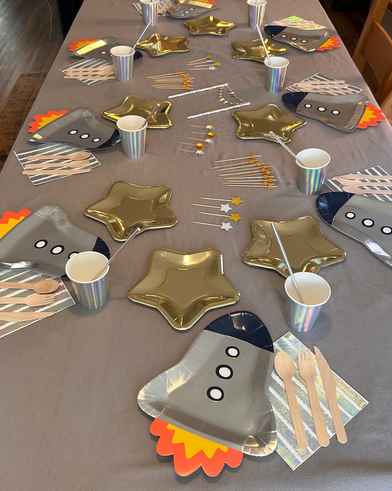 Children's space themed birthday party project with paper plates and decorations on a table
