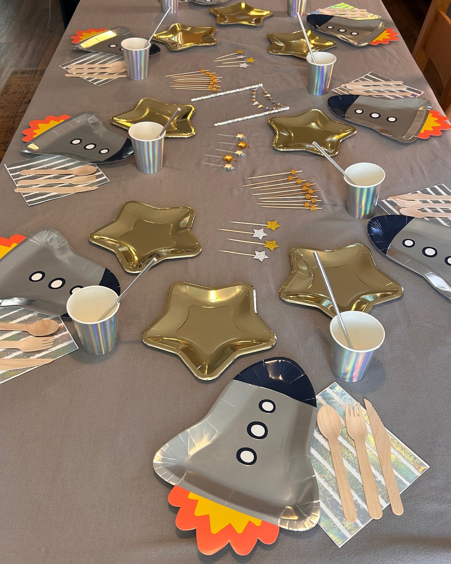 Collection of paper plates shaped like various objects on a table.